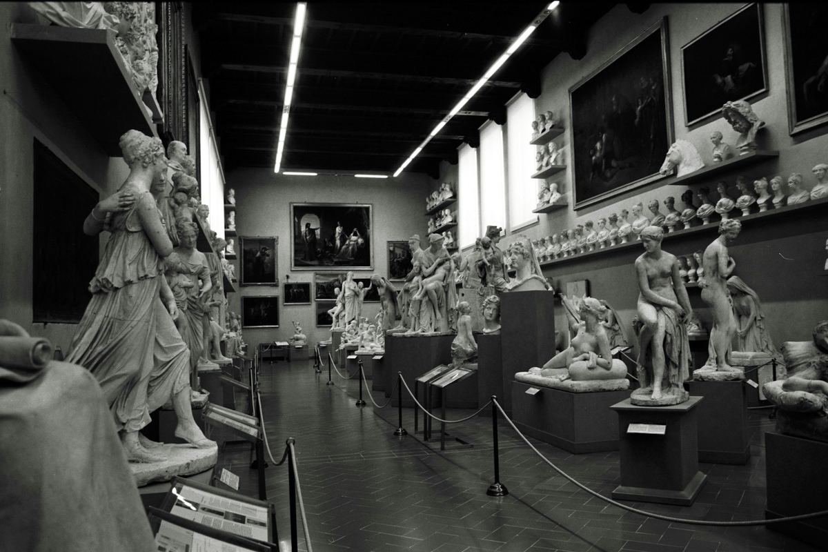 Gallery interior with classical sculpture and paintings