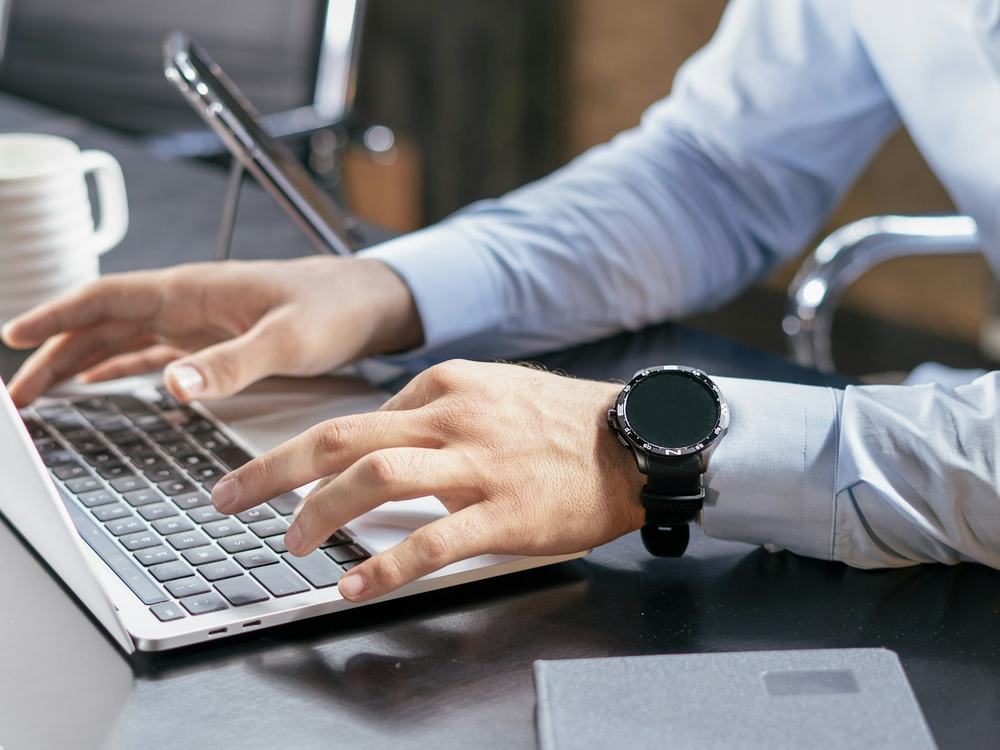 Person working on a laptop at a desk