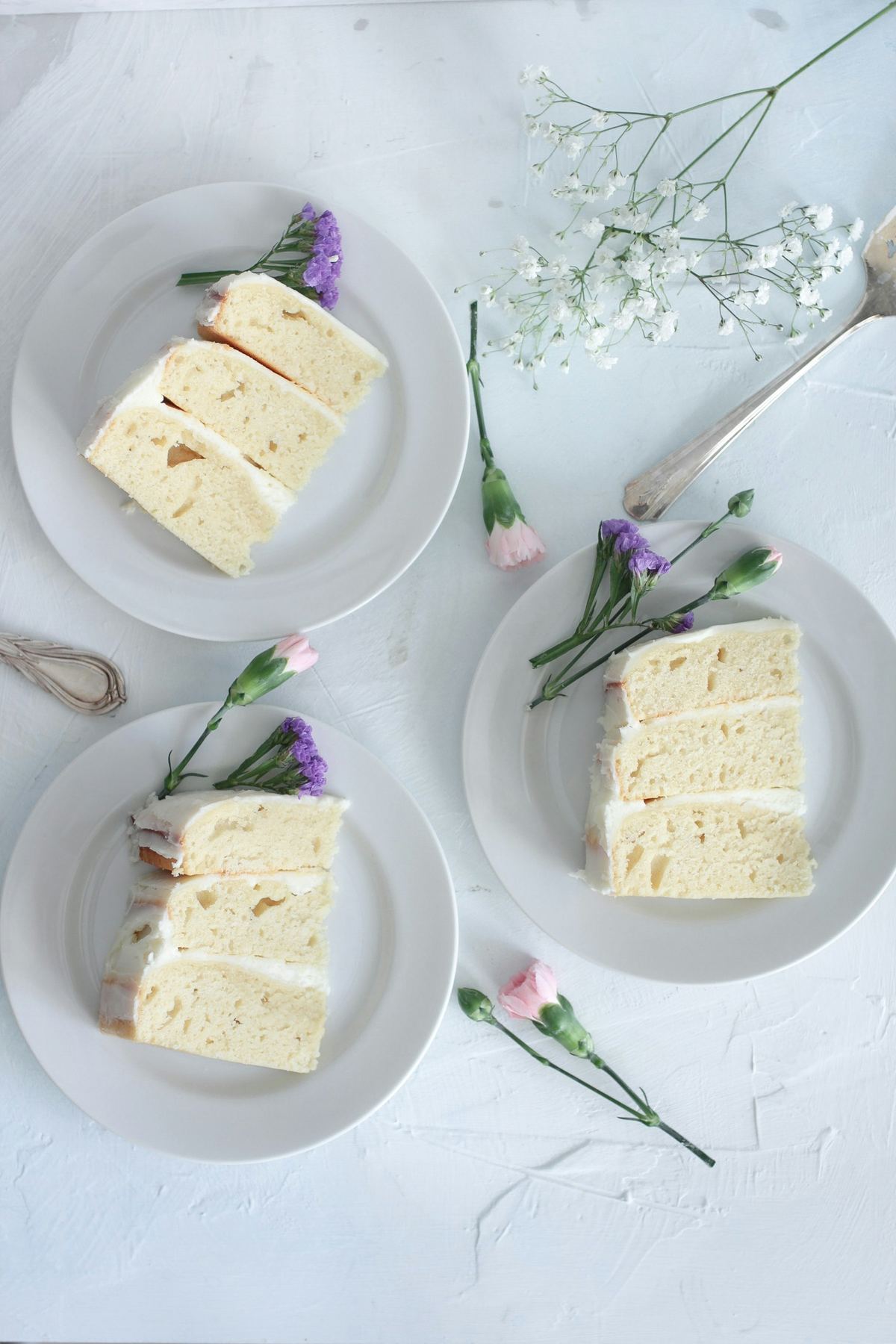Styled slices of layered cake with fresh flowers